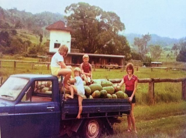 Aldy with her three children and a load of melons